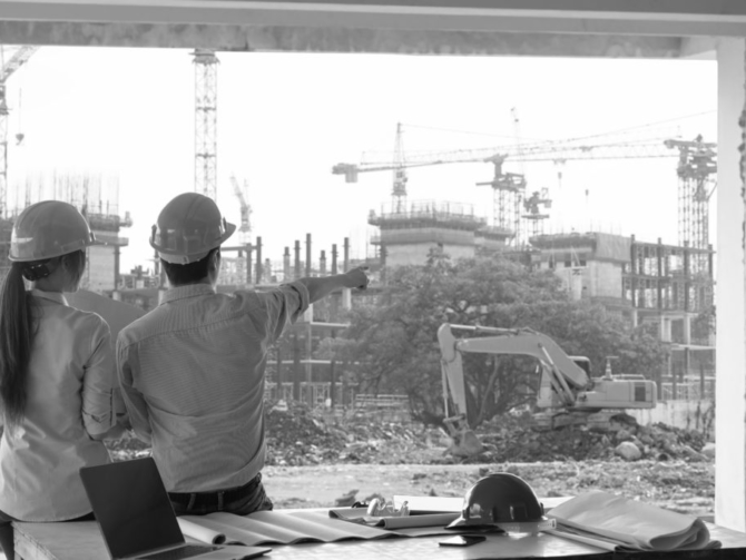 Engineer group and worker meeting, discussion with construction blueprint on site work and point finger to the work site
